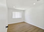 Thumbnail 18 of 31 - Empty bedroom with wood style flooring at Coventry Square Apartments, Upland, CA 97186