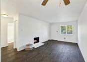 Thumbnail 18 of 21 - A room with a fireplace and a window.