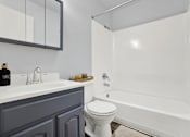 Thumbnail 21 of 21 - A white toilet sits next to a white bathtub in a bathroom.
