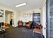 Thumbnail 13 of 21 - A room with a couch, chairs, and pictures on the wall.