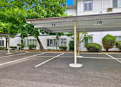 Thumbnail 18 of 28 - A parking lot with a white canopy and number 115 on it.