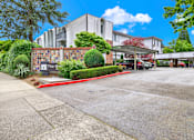 Thumbnail 5 of 28 - A parking lot in front of a building with a sign that reads "The Ridge".