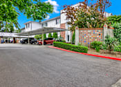 Thumbnail 4 of 28 - A white building with a red line on the sidewalk.