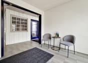 Thumbnail 21 of 28 - Two grey chairs are placed in front of a white wall.