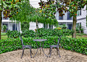 Thumbnail 6 of 28 - A patio with a table and two chairs.