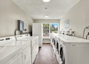Thumbnail 10 of 28 - A laundry room with washers and dryers.