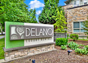 Thumbnail 7 of 23 - A sign for Delano Luxury Rentals in front of a building.