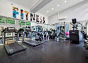 Thumbnail 16 of 23 - A gym with a variety of equipment including treadmills, exercise bikes, and weights.