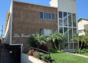 Thumbnail 3 of 12 - Signage, Garage, Building Front With Brick Detailing and Large Windows at Wilson Apartments in