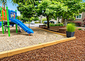 Thumbnail 4 of 25 - A playground with a blue slide and a green climbing frame.