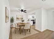 Thumbnail 4 of 31 - Dining area with wood table and ceiling fan at Coventry Square Apartments, California