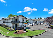 Thumbnail 15 of 33 - A white building with a sign that says Arden Park Apartments.