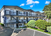 Thumbnail 3 of 21 - A large white building with a balcony on the second floor.