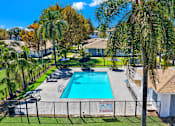 Thumbnail 2 of 31 - Swimming pool with patio furniture and iron fencing at Coventry Square Apartments, Upland, California