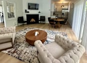 Thumbnail 18 of 25 - A living room with a fireplace and a television.