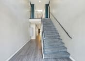 Thumbnail 23 of 25 - A staircase with a metal railing and wooden steps.at Federal Apartments, Los Angeles, CA