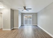 Thumbnail 9 of 25 - A room with a ceiling fan and wooden flooring.at Federal Apartments, Los Angeles, CA