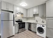 Thumbnail 10 of 25 - A modern kitchen with a stainless steel refrigerator and a white dishwasher.at Federal Apartments, Los Angeles, 90025