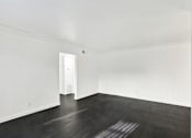 Thumbnail 38 of 41 - A room with a white door and wooden floor. at Elmwood Gardens, Burbank, California