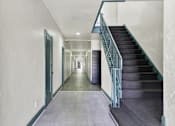 Thumbnail 16 of 19 - Long hallway with a staircase at Hobart Apartments, Los Angeles, 90029