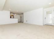 Thumbnail 50 of 52 - A large empty room with a door on the right side.