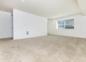 Thumbnail 36 of 52 - the spacious living room has white walls and carpeting and a window  at Delano, Washington, 98052
