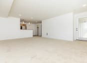 Thumbnail 24 of 52 - the living room and kitchen of an empty home with white walls and carpet  at Delano, Redmond, 98052
