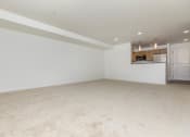 Thumbnail 38 of 52 - an empty living room and kitchen with white walls and carpet  at Delano, Redmond, WA