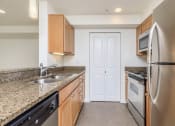 Thumbnail 7 of 52 - a kitchen with granite counter tops and stainless steel appliances at Delano, Redmond