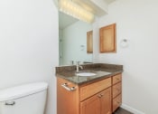 Thumbnail 8 of 52 - a bathroom with a sink and toilet and a mirror at Delano, Redmond, WA 98052