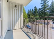 Thumbnail 19 of 52 - a balcony with a view of a parking lot and trees  at Delano, Redmond