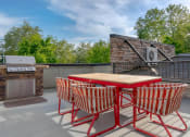 Thumbnail 6 of 52 - a patio with a table and chairs and a grill at Delano, Redmond Washington