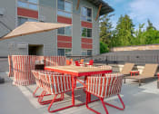 Thumbnail 20 of 52 - a patio with tables and chairs and a building in the background  at Delano, Washington