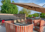 Thumbnail 30 of 52 - a patio with tables and chairs and an umbrella  at Delano, Redmond, WA 98052