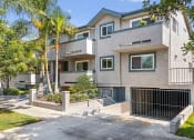 Thumbnail 2 of 6 - Property Exterior Front Entrance with Garage at Elmwood Gardens Apartments in Burbank, CA
