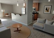 Thumbnail 56 of 59 - A living room with a grey couch and a brown coffee table.