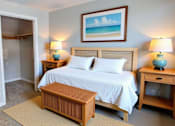 Thumbnail 57 of 59 - A bedroom with a bed, nightstands, and a painting on the wall.