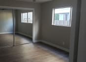 Thumbnail 5 of 12 - Sliding Door Closet with Mirror in Bedroom at Wilson Apartments in Glendale, CA