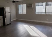 Thumbnail 6 of 12 - Kitchen Area With AC Unit, Hard-Wood Flooring, Plenty of Natural Light at Wilson Apartments in Glendale, CA