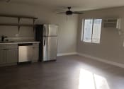 Thumbnail 7 of 12 - Kitchen Area With Ceiling Fan, Hardwood Flooring, Stainless Steel Appliances at Wilson Apartments in Glendale, CA