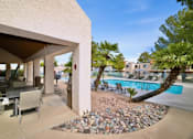 Thumbnail 6 of 35 - A patio area with a table and chairs is shown.
