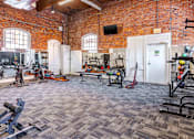 Thumbnail 89 of 98 - A gym with a variety of exercise equipment is shown.