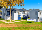 Thumbnail 4 of 22 - A row of houses with a sign that says Park Place Apartments.