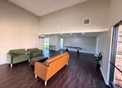 Thumbnail 10 of 11 - A living room with a sofa, two chairs, and a coffee table.