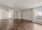 Thumbnail 21 of 22 - A room with wooden flooring and a ceiling fan.