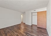 Thumbnail 7 of 22 - A room with wooden floors and white walls.