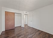 Thumbnail 11 of 22 - A room with a white wall and a brown door.