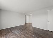 Thumbnail 25 of 28 - A room with wooden flooring and white walls.
