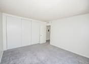 Thumbnail 22 of 27 - A room with white walls and a grey carpet.