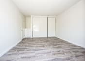 Thumbnail 27 of 27 - A room with a white door and a grey floor.